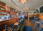 The long wood bar inside Nessun Dorma